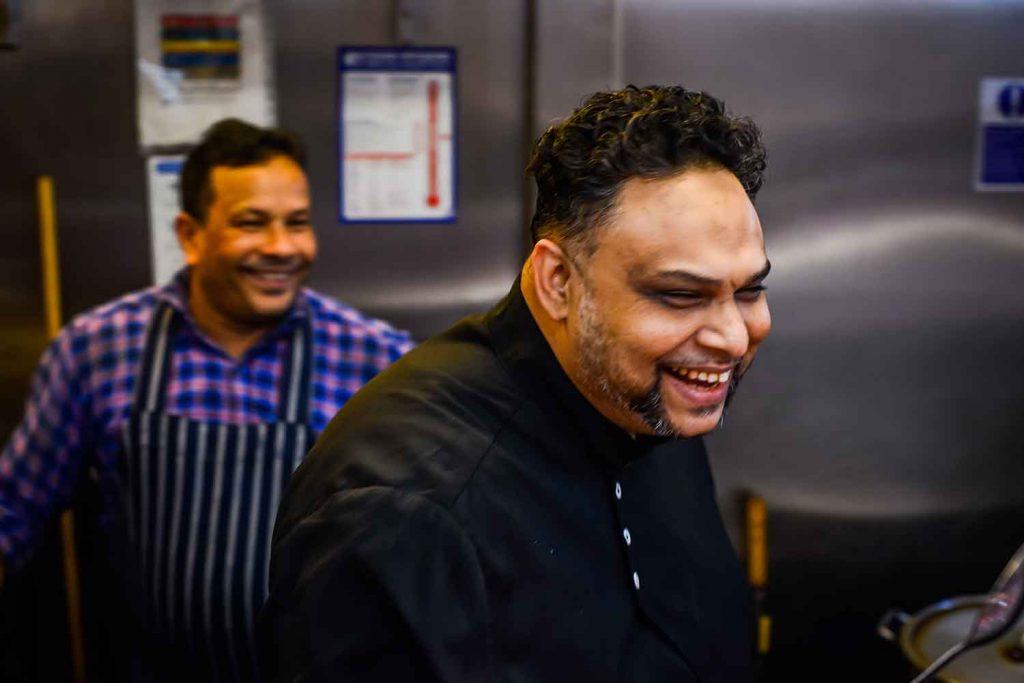 Celebrity chef Atik Rahman laughing in the kitchen.